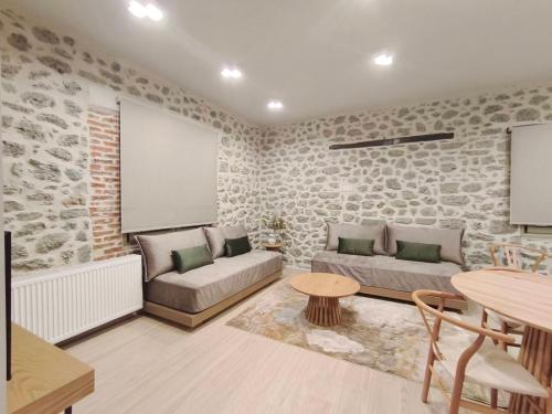 a living room with a couch and a table at Meteora Kalimera 1 in Kalabaka