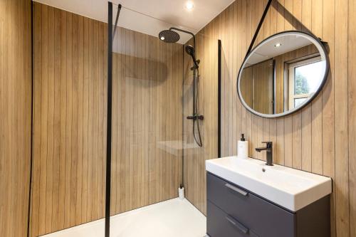 a bathroom with a sink and a mirror at Cosy town centre cottage in Peebles