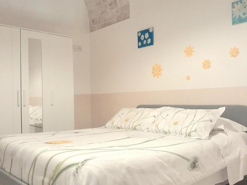 a bedroom with a bed with white sheets at B&B Margherita in Putignano