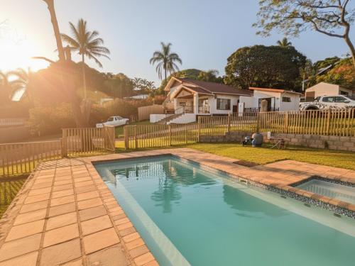 a swimming pool in a yard with a fence at Rembrandt - Zur See in Ballito