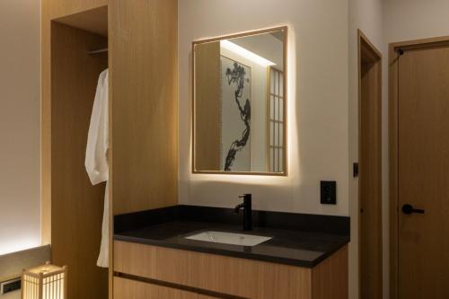 a bathroom with a sink and a mirror at Bucheon Daon Hotel in Bucheon