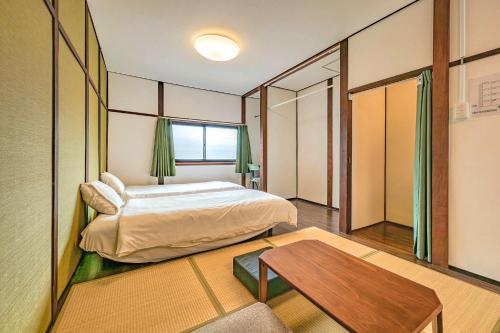 a bedroom with a bed and a table in it at YAGARA TERRACE HOUSE OSAKA Room D in Osaka