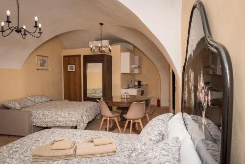 a living room with two beds and a dining room at Residence Fusconi in Norcia