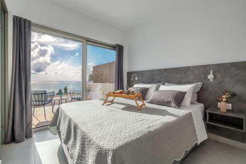 a bedroom with a bed with a view of the ocean at Villa Harmonie in Achlia