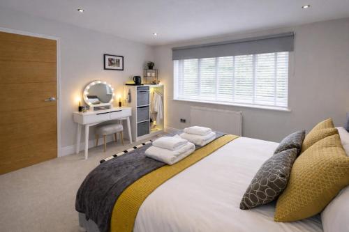 a bedroom with a bed with a desk and a mirror at Margate Duplex with Private Terrace Air Conditioning The Duplex Margate in Margate