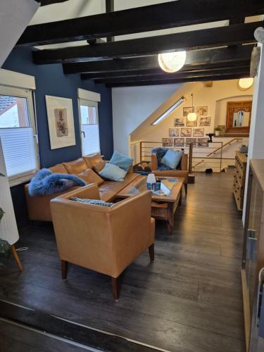 a living room with couches and tables in a room at Rebenhaus St Martin in Sankt Martin