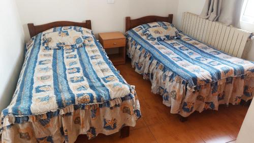 two beds sitting next to each other in a room at 2-Bedroom Chalet for Ski and Summer in Kfardebian