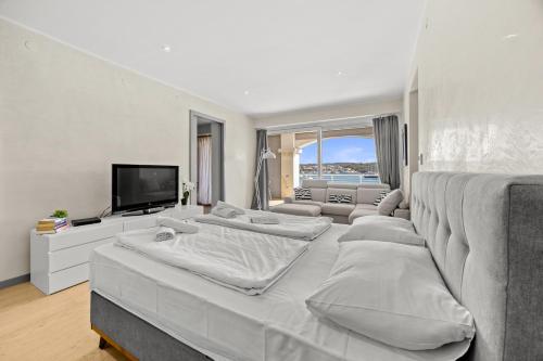 a living room with four beds and a flat screen tv at Villa Laura in Pula