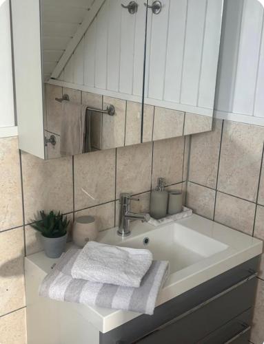 a bathroom sink with two towels and a mirror at Casa Brekka in Bamble