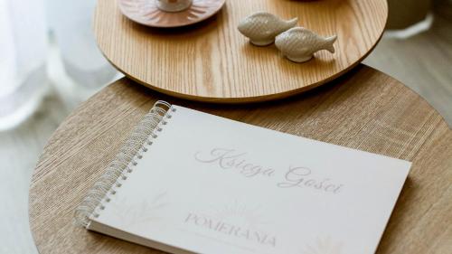 a table with two plates of food and a notebook at Baltic Line - Pomerania in Gdańsk