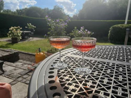 two wine glasses sitting on top of a table at Lundtoftegaard in Kongens Lyngby