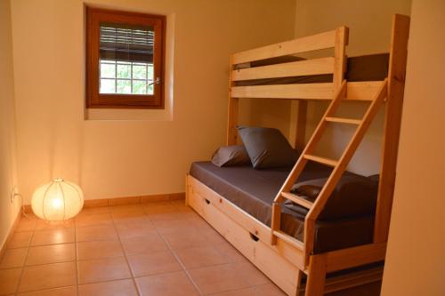 a bedroom with two bunk beds and a window at Mas Salvador Rural Experience in Llagostera