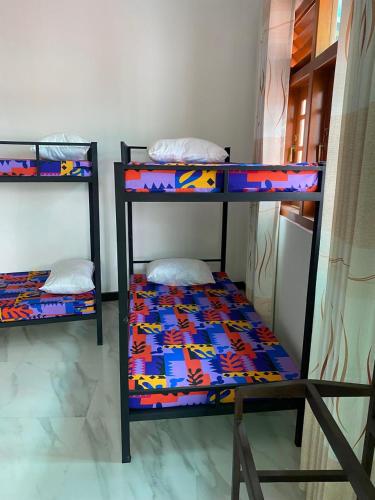 a room with two bunk beds in a room at Chandani Hostel in Galle