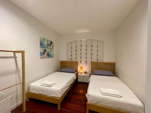 two beds in a small room with at The Serene House Bangkok in Bangkok