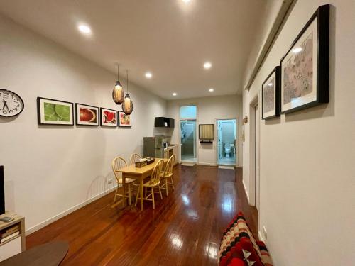 a living room with a table and a dining room at The Serene House Bangkok in Bangkok