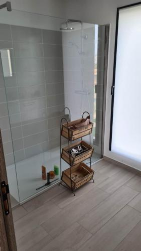 a bathroom with a shower and a glass door at Villa U Picculu in Lecci