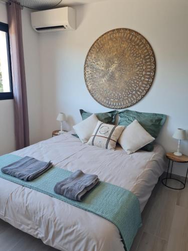 a bedroom with a bed with two towels on it at Villa U Picculu in Lecci