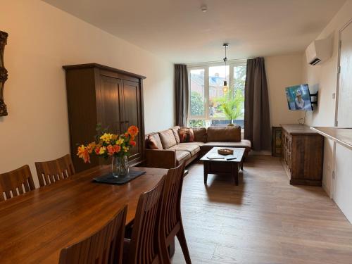 a living room with a couch and a table at Strijp Appartments in Eindhoven