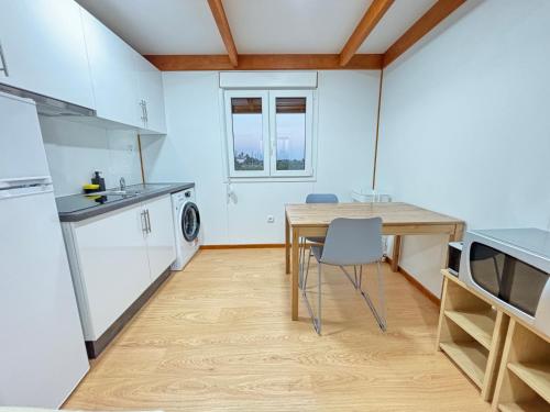 a kitchen with a wooden table and a dining room at Grape Escape, By Home Match in Palmela