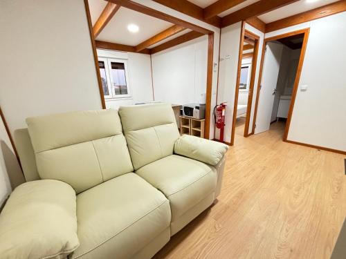 a living room with a white couch and wooden floors at Grape Escape, By Home Match in Palmela