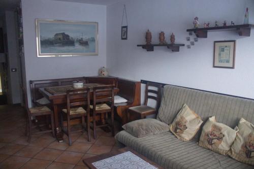 a living room with a couch and a table at Cervinia Apartments in Breuil-Cervinia