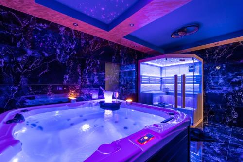 a jacuzzi tub in a room with purple lighting at Villa Bellezza in Draga Bašćanska