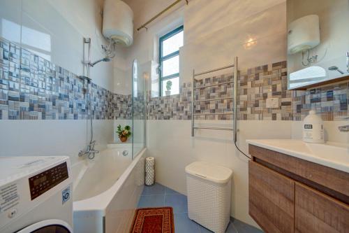 a bathroom with a sink and a washing machine at Charming Central 2BR Townhouse with Rooftop Terrace in St. Julianʼs