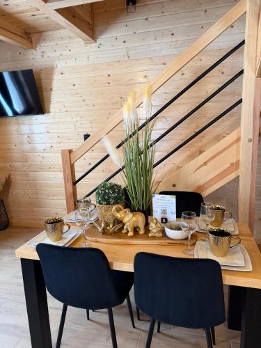 a wooden table with wine glasses and plants on it at Perła Kaszub in Wiele