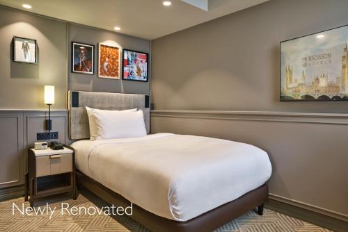 a hotel room with a bed and a picture on the wall at Radisson Blu Hotel, London Bond Street in London