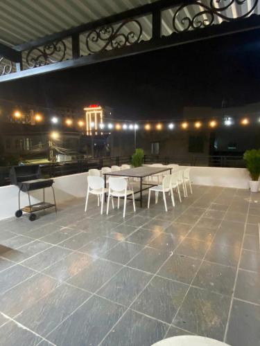 a table and chairs on a patio at night at Homestay Lumina in Dong Hoi