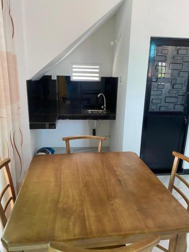 a wooden table in a kitchen with a sink at Chandani Hostel in Galle