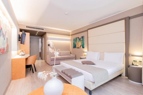 a bedroom with a large white bed and a desk at Park Hotel Ai Pini & Restaurant Ai Pini in Mestre
