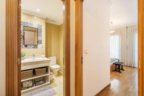 a bathroom with a sink and a toilet at Sunny Beachside Escape by Minho's Guest in Póvoa de Varzim