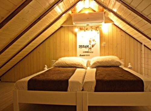 a bed in a room with an attic at Menego Lodge Bol in Bol