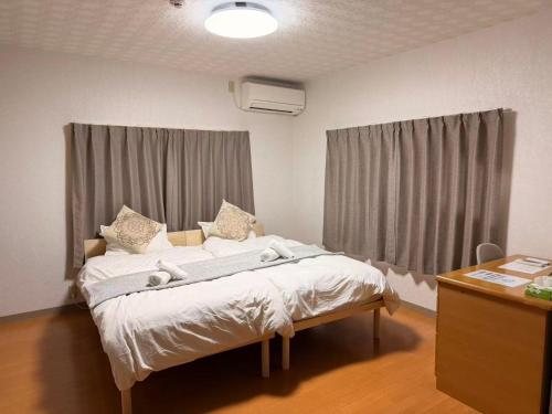 a hospital room with a bed and a desk at Roomy 4BR Home Sleeps 9／ShinOsaka／Large Groups in Osaka