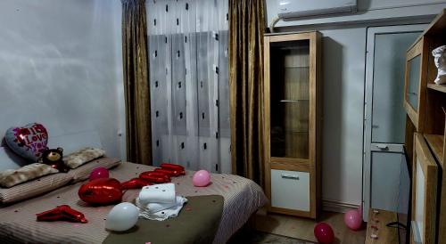 a bedroom with a bed with balloons on it at Mazepa 2 You in Galaţi