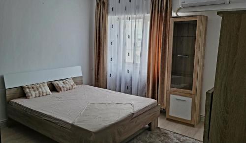 a small bedroom with a bed and a window at Mazepa 2 You in Galaţi