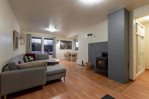 a living room with a couch and a fire place at Free EV Charging with Snacks and View in Blesom