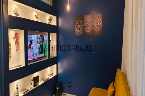 a room with a blue wall with signs on it at Studio 3 Praias in São Vicente