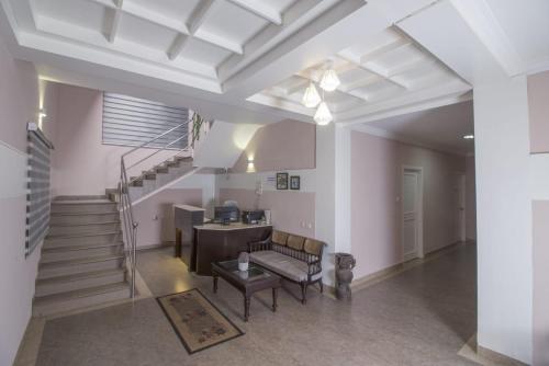a living room with a staircase and a table at Mounts shelts in Munnar