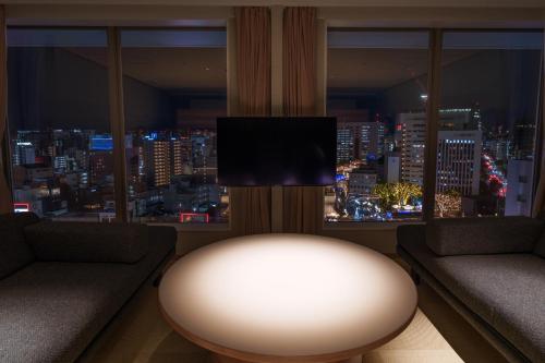 a living room with a view of a city at Hotel Resol Trinity Hakata in Fukuoka
