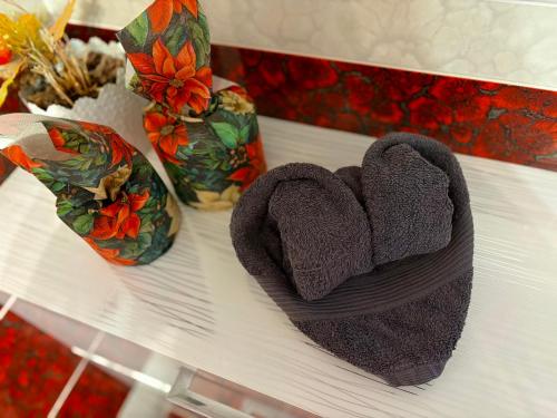 a white table with two towels and two vases at Spa Residence beltéri jakuzzi inside jakuzzi in Veszprémfajsz