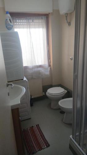 a small bathroom with a toilet and a sink at A Casa Di Mina in Civitavecchia
