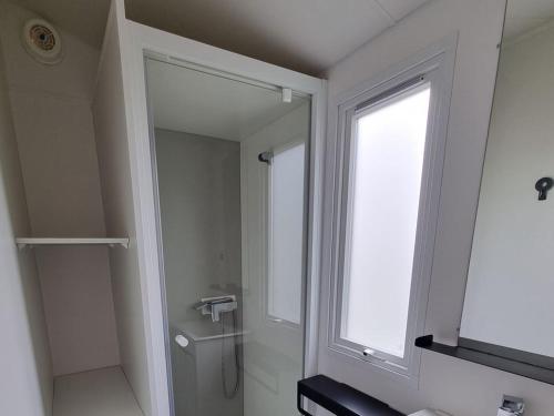a bathroom with a large mirror and a window at Camping de Ceyreste - Maeva in La Ciotat