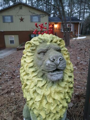 a statue of a lion covered in yellow hair at Rasta House Fantasy in Lithia Springs