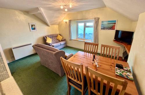 a living room with a table and a couch at The Lookout in Ilfracombe