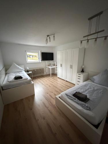 a bedroom with two beds and a television in it at MELLoWY Monteure, TV, Küche, Bad in Gaggenau