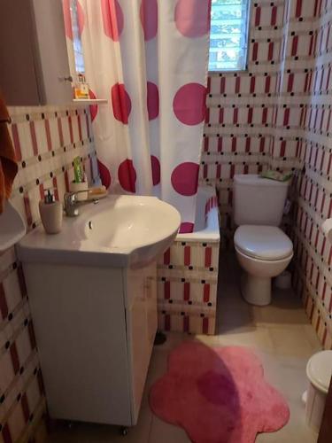 a bathroom with a sink and a toilet at The Vintage House in Nea Moudania