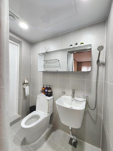 a bathroom with a toilet and a sink at Kintex Central Stay 3BR 2Bath Spacious Space in Ilsan-yŏk