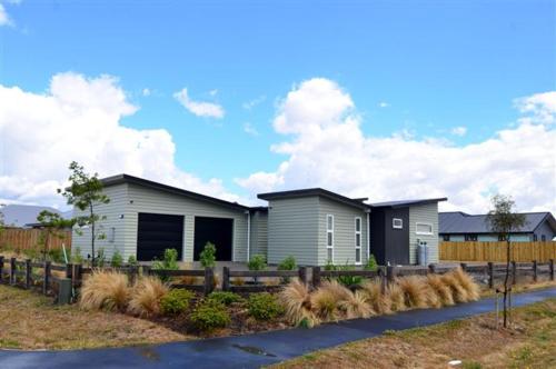 a house with a fence in front of it at Amberley Serviced Apartments in Amberley